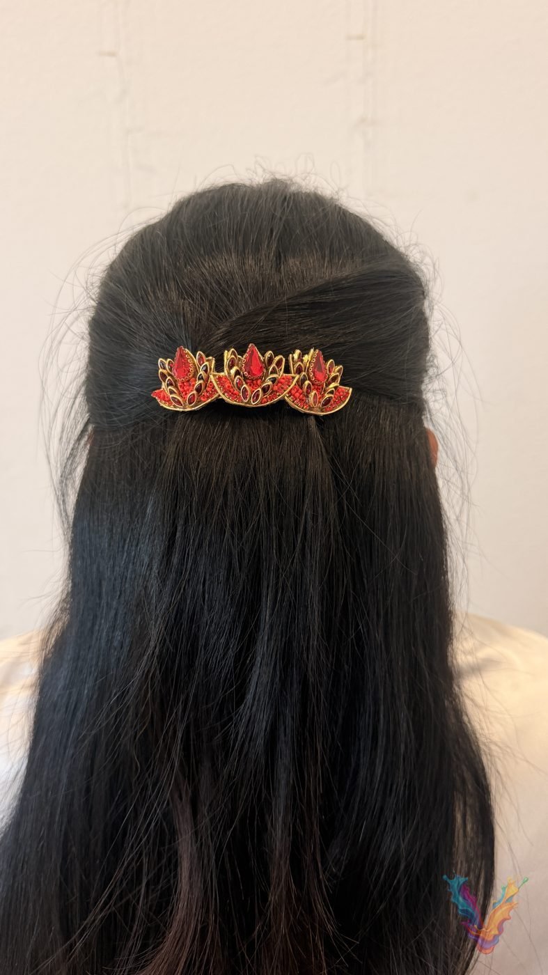 Red lotus motif hair clip in dark hair
