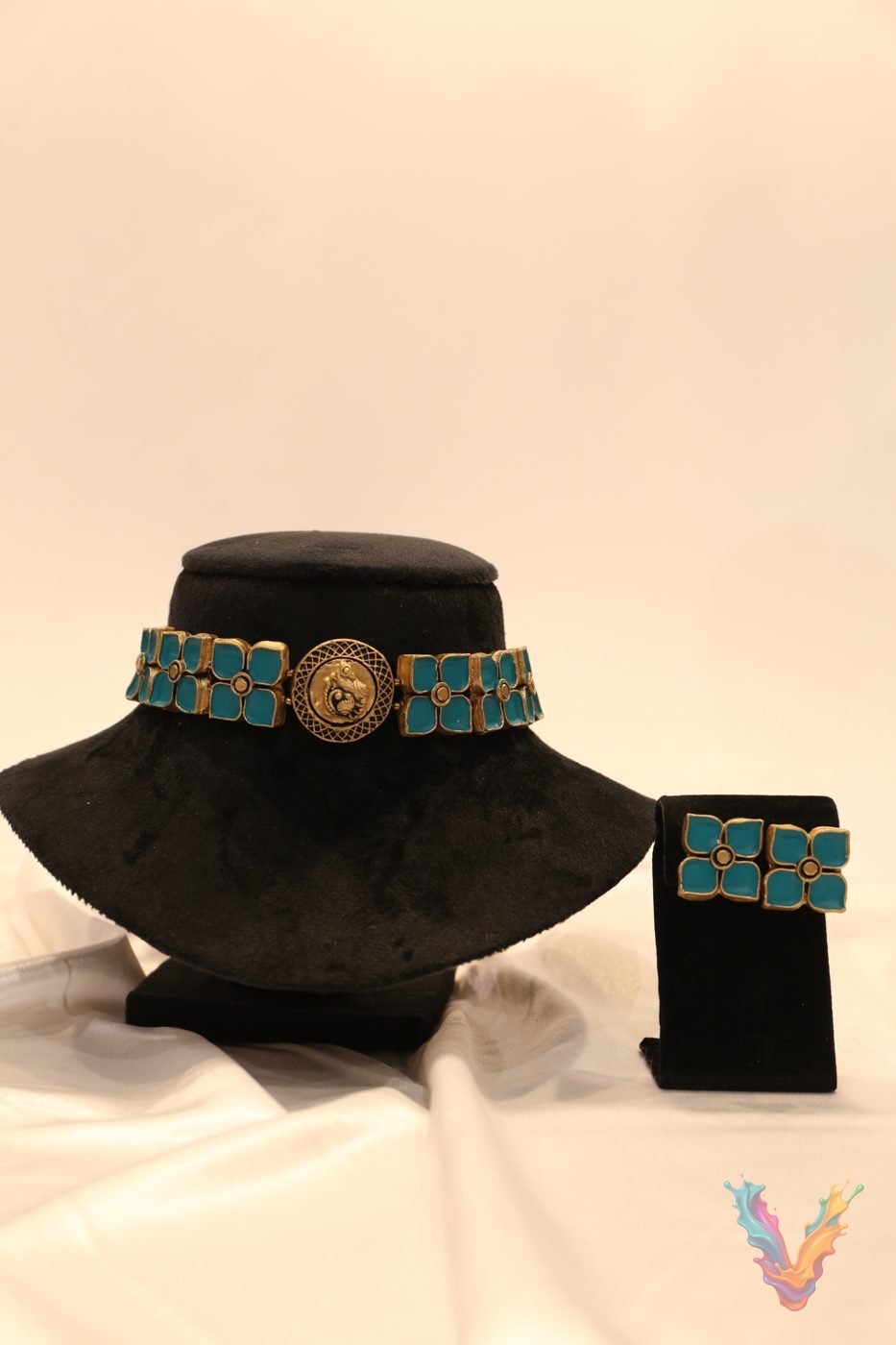 Turquoise terracotta choker displayed on a black bust with matching earrings